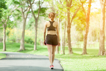 Asian woman warming up before running in the park