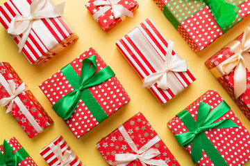 Obraz premium A lot of Christmas gift boxes in colored paper decorated on table, Top view close up. Many present New Year gift