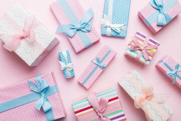 A lot of Christmas gift boxes in colored paper decorated on table, Top view close up. Many present New Year gift