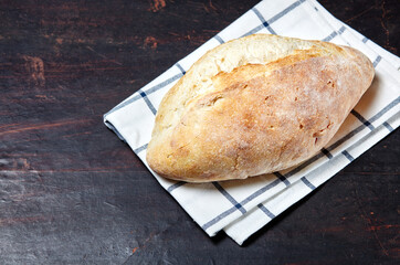 Bread on a wooden background. Fresh bakery on dark kitchen table