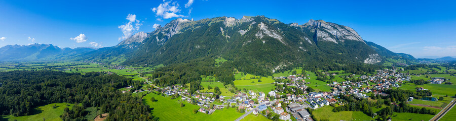 Aerial view around the city Sennwald in Switzerland on a sunny morning day in summer.