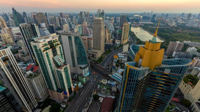 Aerial view of Siam Bangkok intersection or junction with cars traffic skyscraper buildings. Bangkok City in downtown at night, Thailand. 