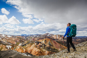 hiker with backpack enjoying the landscape of Iceland while hiking the Laugavegur trail