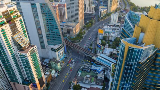 Time lapse of aerial view of Asoke intersection or junction with cars traffic, Bangkok Downtown. Thailand. Financial district in smart urban city and technology concept
