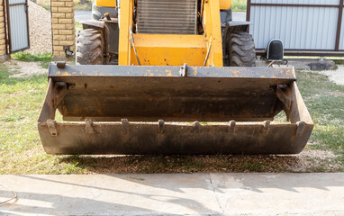 The tractor is working with rubble on the road.