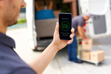 Delivery man holding smart phone with mobile application