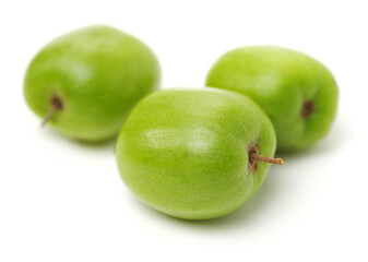 mini kiwi baby fruit (actinidia arguta) on white background 