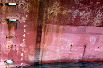 Ship board with numbers for water level. Rusty iron texture.