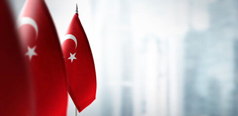Small flags of Turkey on a blurry background of the city