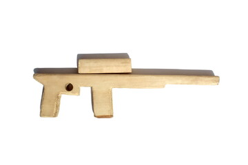 Wooden toy homemade weapon machine gun lies on a white background.