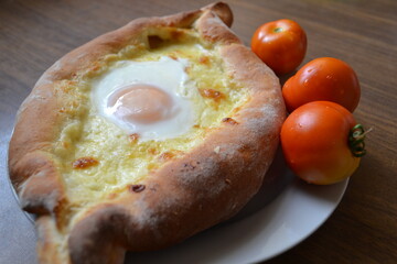 Khachapuri with tomatoes.