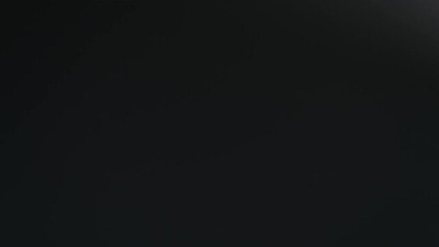 Blurry dark shadows moving on the wall. Spooky shadow art noise texture. closeup the motion of shadow batten of lath light on white wall texture background. Slow motion video. stock footage