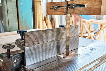 Industrial band saw machine in a carpentry or lumber workshop.