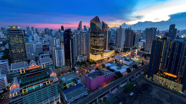 Aerial view of Siam Bangkok intersection or junction with cars traffic skyscraper buildings. Bangkok City in downtown at night, Thailand. 
