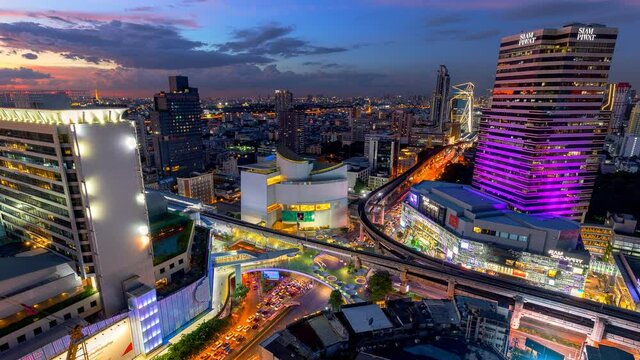 Aerial view of Siam Bangkok intersection or junction with cars traffic skyscraper buildings. Bangkok City in downtown at night, Thailand. 