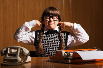 Little girl runs a business. She is overworked. Business concept.