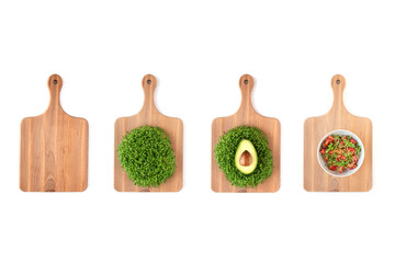 Wooden kitchen boards with microgreens alfalfa sprouts, avocado and salad with tomatoes