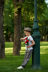 Boy with bouquet waiting for girl, children's date