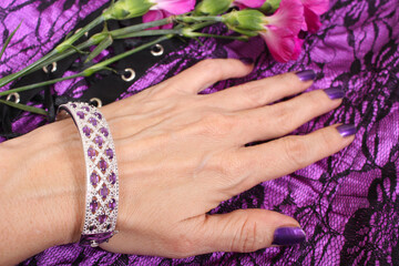 Woman with Silver and Amethyst Bracelet on Purple and Black Lace