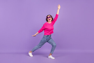 Full length body size view of attractive cheerful funky woman dancing having fun good mood isolated over violet purple color background