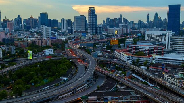 Aerial view of Siam Bangkok intersection or junction with cars traffic skyscraper buildings. Bangkok City in downtown at night, Thailand. 