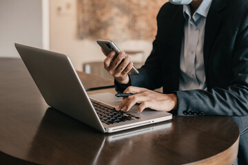 Send a message to a colleague, a businessman, confident in matching a laptop and sitting in cafe.