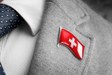 Metal badge with the flag of Switzerland on a suit lapel