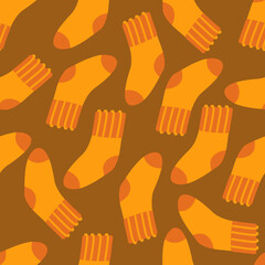 Fototapeta premium Wool socks orange autumn seamless pattern on a brown background. Vector illustration in a flat style for printing on paper, fabric, packaging, textiles.