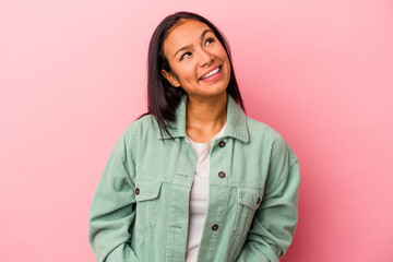 Young latin woman isolated on pink background  relaxed and happy laughing, neck stretched showing teeth.