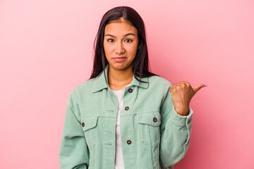 Young latin woman isolated on pink background  shocked pointing with index fingers to a copy space.