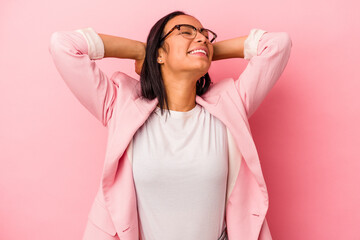 Young latin woman isolated on pink background  feeling confident, with hands behind the head.