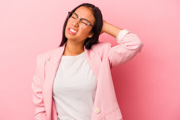Fototapeta premium Young latin woman isolated on pink background tired and very sleepy keeping hand on head.