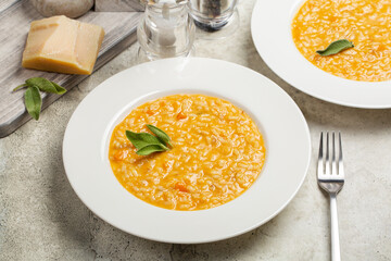 Risotto with pumpkin and taleggio cheese, decorated with sage leaves.