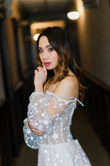 Naklejka premium Young stylish asian woman in white dress, vintage style, natural, innocent, smiling in hotel