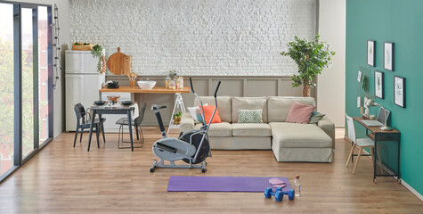 Sport room interior style with sofa and kitchen background, decorative home style, brick wall, vase of plant, sportive decor style.