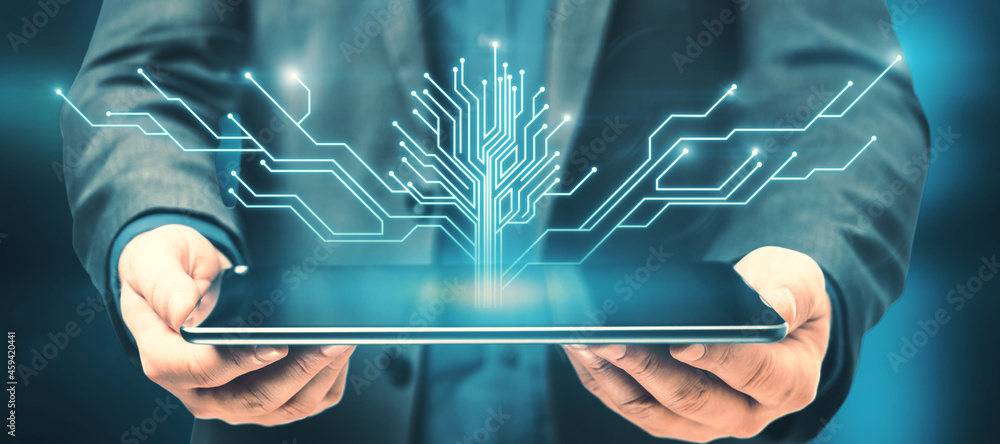 Aufkleber close up of hand holding tablet computer with abstract digital circuit tree on blurry blue backgroun
