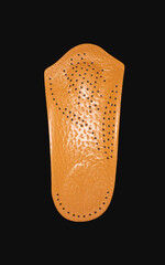 The orthopedic insole on a black background. Treatment and prevention of flat feet and foot diseases. High quality photo