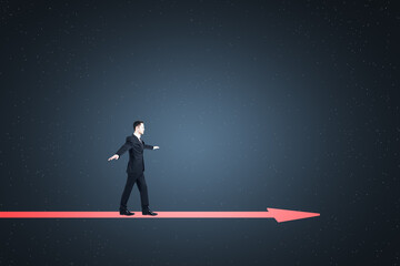 Attractive young european businessman balancing on arrow on abstract starry blue background with...