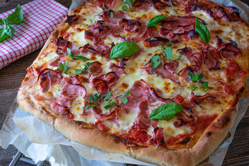 homemade pizza with italian ham, mozzarella cheese and tomato sauce