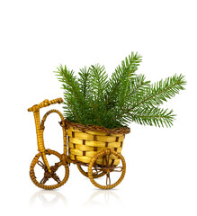 Fototapeta na wymiar Wicker bike with basket and fir sprigs isolated on white background.