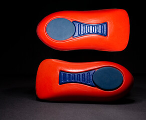The orthopedic insole on a black background. Treatment and prevention of flat feet and foot diseases. High quality photo
