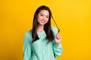 Photo of adorable happy young woman finger hair smile good mood isolated on shine yellow color background