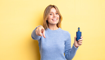 pretty blonde girl pointing at camera choosing you. smoke vaporizer concept