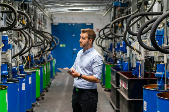 Male inspector checking production line in paint factory