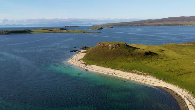Drone shot of Coral Beach in Claigan with white sandy beaches and tropical blue water, in Scotland