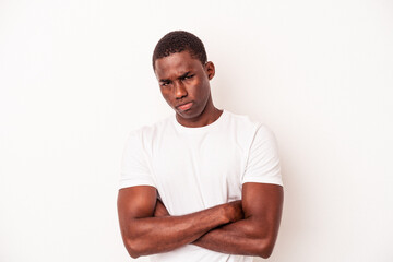 Young African American man isolated on white background frowning face in displeasure, keeps arms folded.