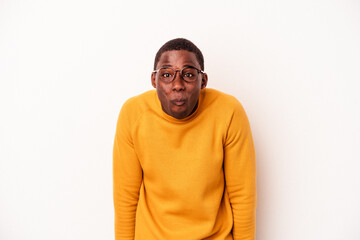 Young African American man isolated on white background shrugs shoulders and open eyes confused.