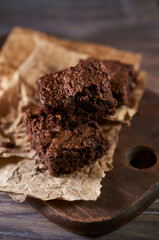 Freshly baked tasty chocolate brownies on a wooden background