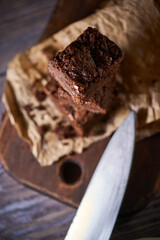 Freshly baked tasty chocolate brownies on a wooden background