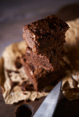 Freshly baked tasty chocolate brownies on a wooden background
